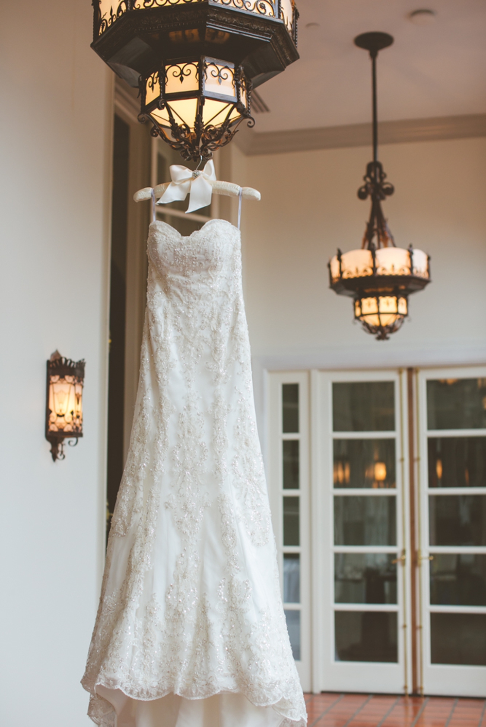 Bride's Dress Hanging on Light Fixture