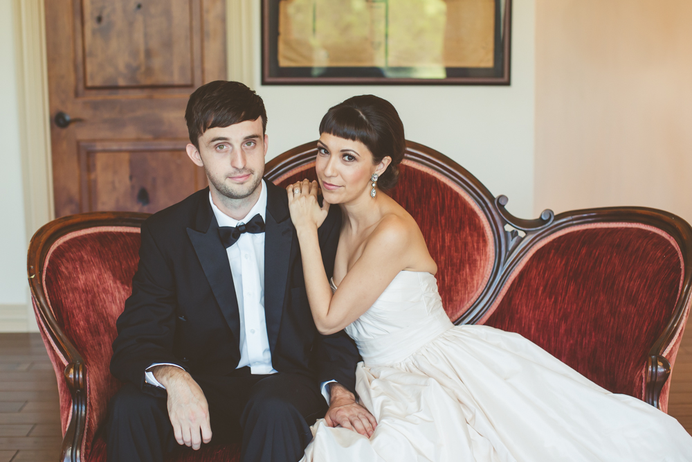 bride and groom on vintage couch