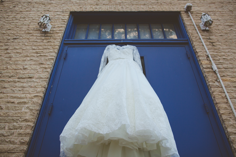 wedding dress on a blue door