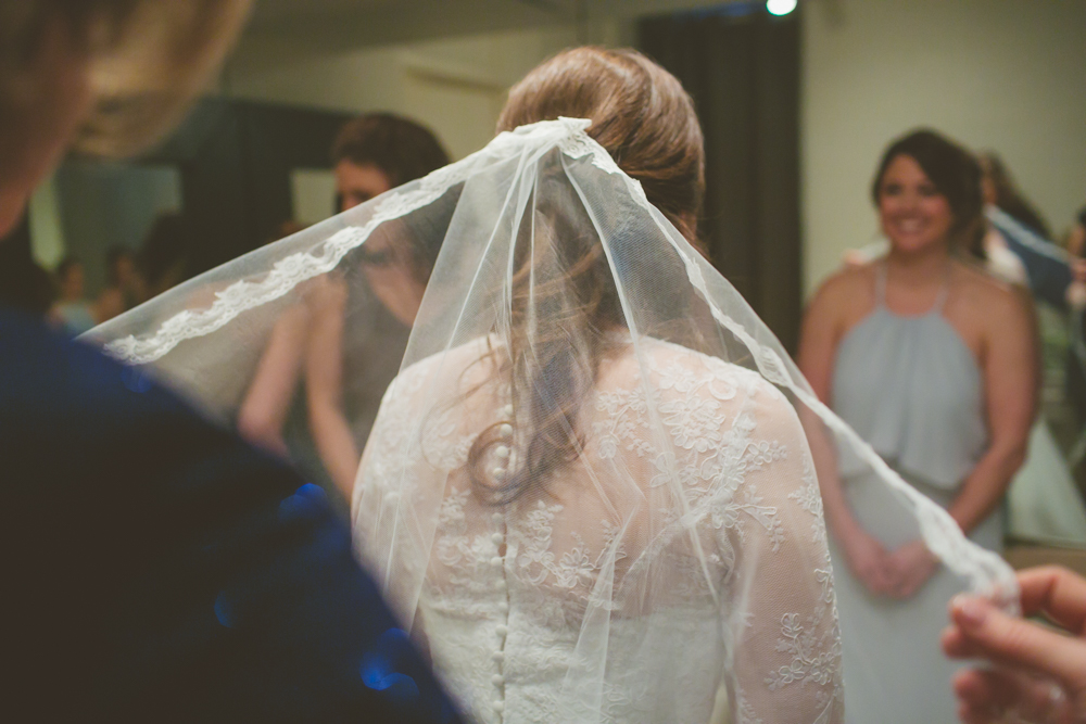mom adjusting bride's veil