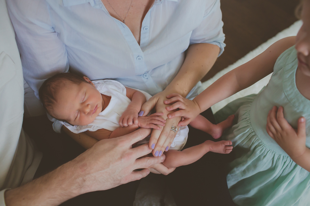 close up of hands on newborn baby