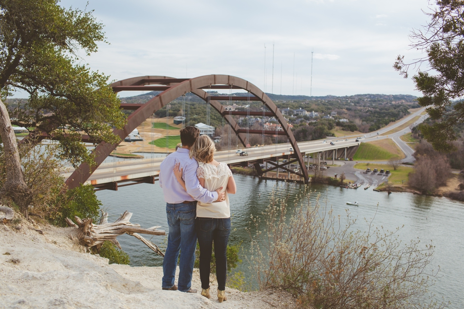 engaged couple standing near 360 bridge