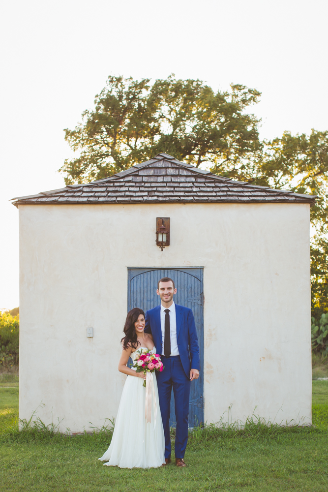 bride and groom by blue door