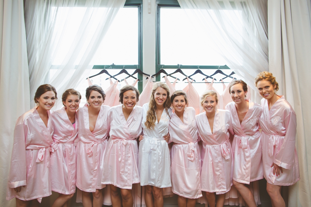 Bride and Bridesmaids in front of dresses