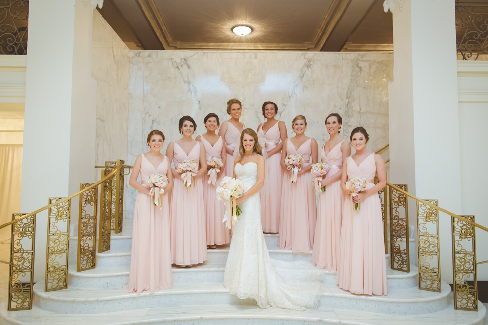 bride and bridesmaids St. Anthony hotel on the stairs