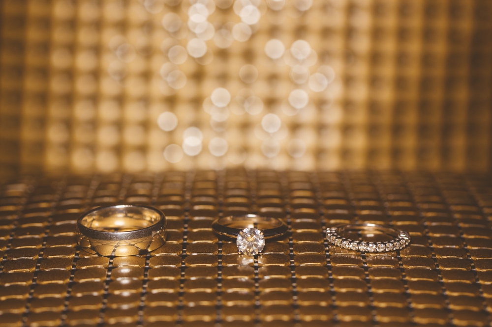 Wedding Rings on Gold Sparkle Background