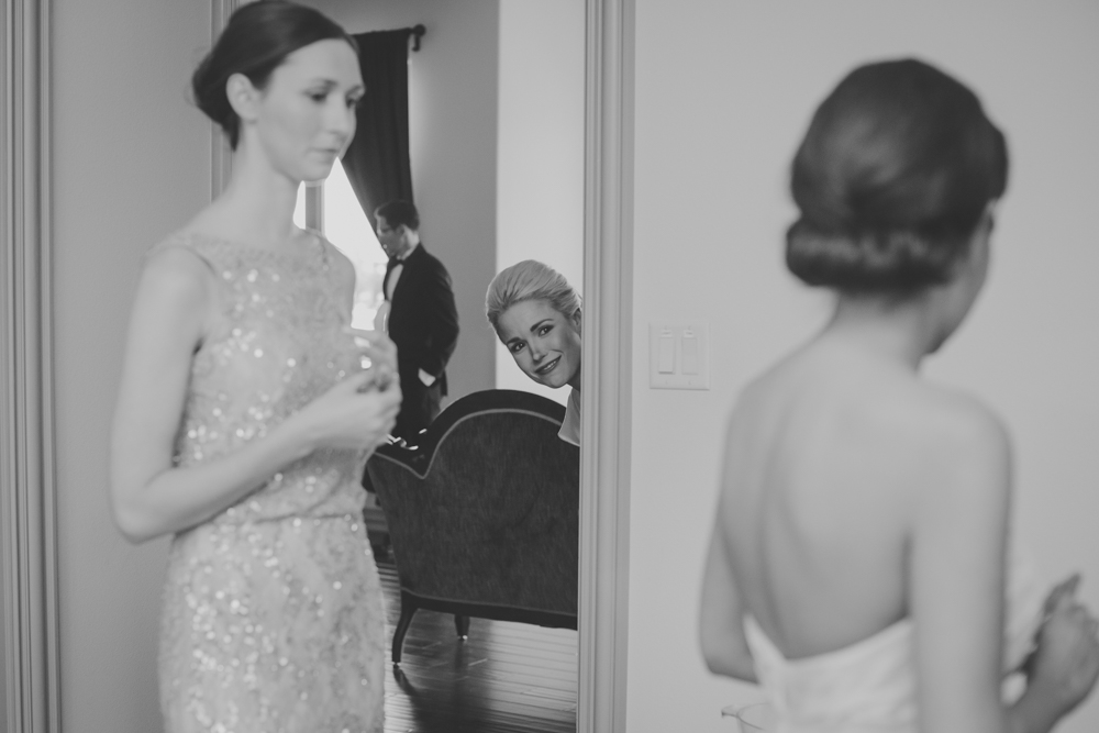 bridesmaid peeking at bride