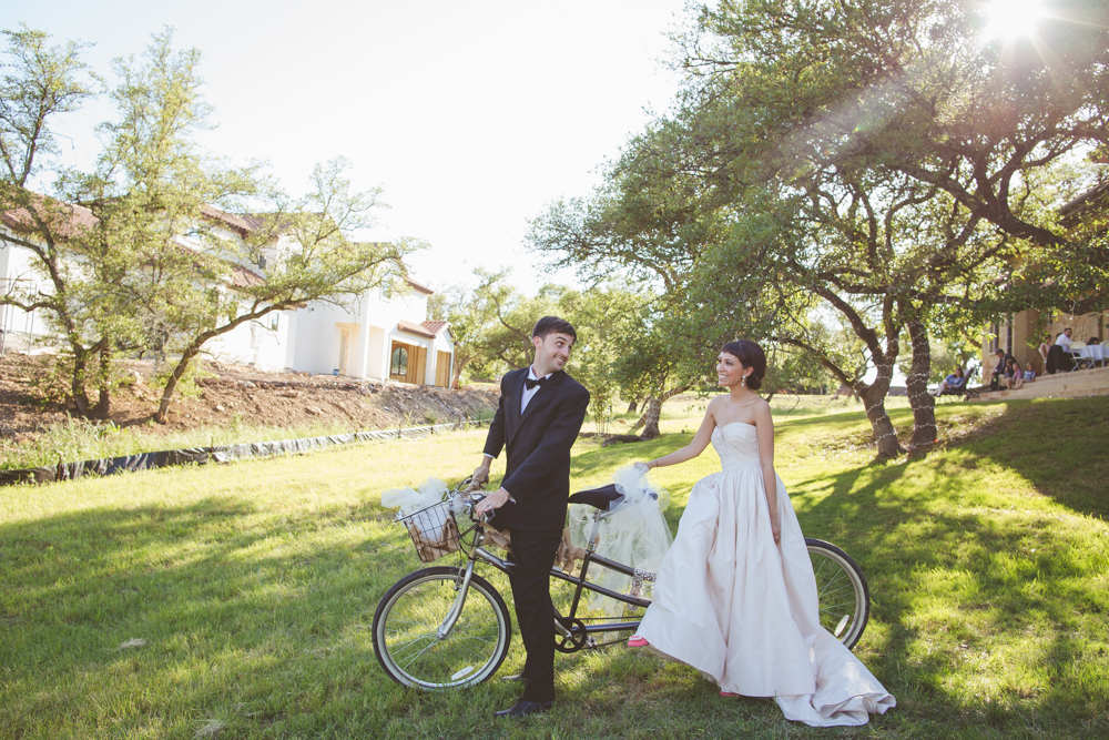 bride and groom on tandem bicycle