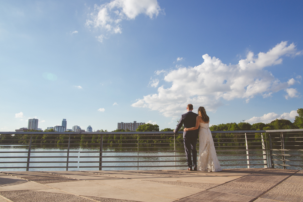 bride and groom looking at austin skyline