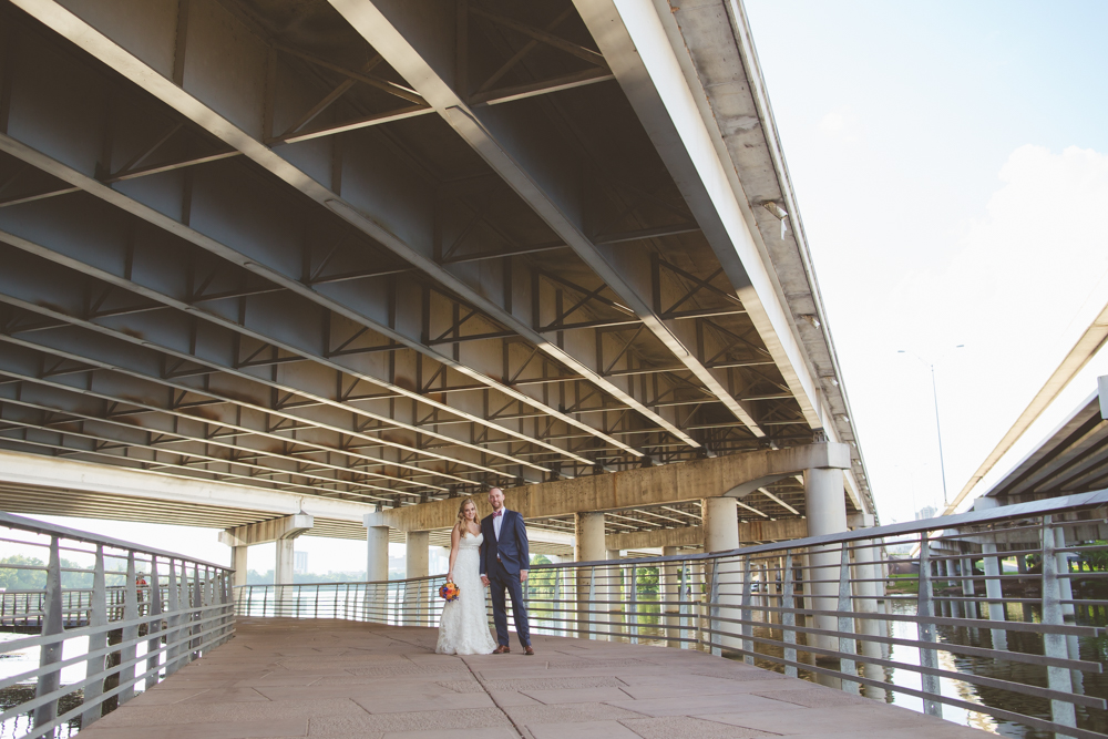 bride and groom under interstate during day after session