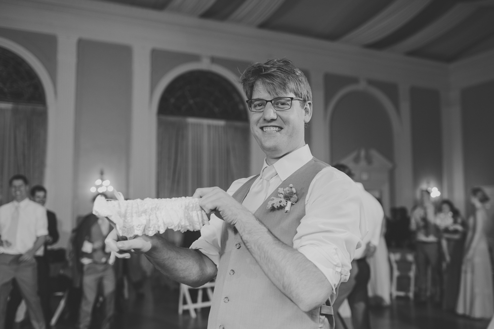 groom tossing the garter