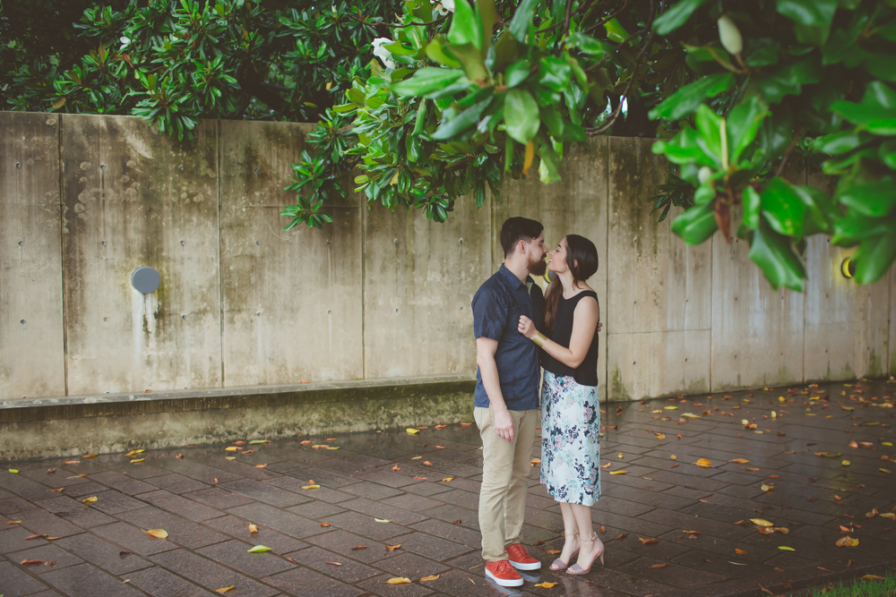 couple kissing under magnolia tree