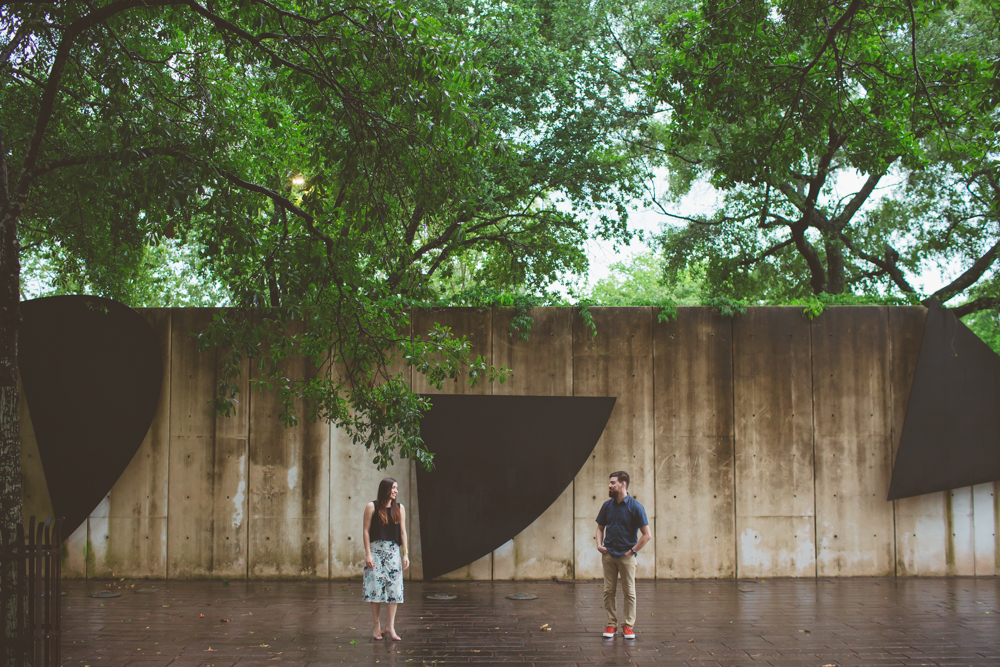 couple standing in sculpture garden