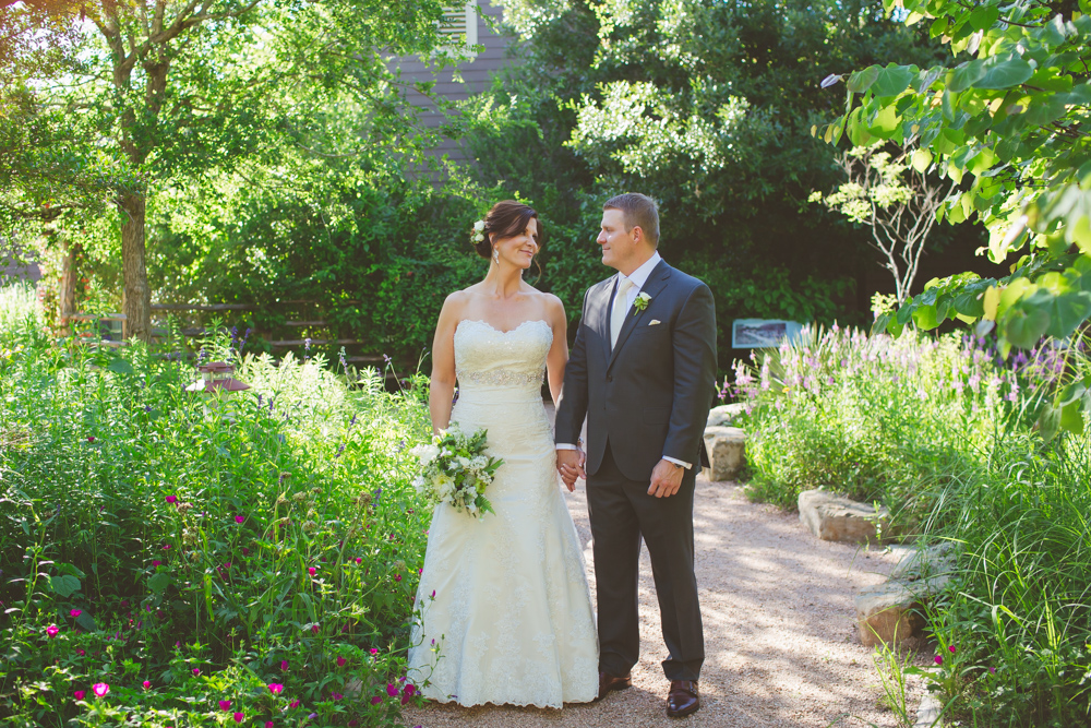 bride and groom in butterfly garden