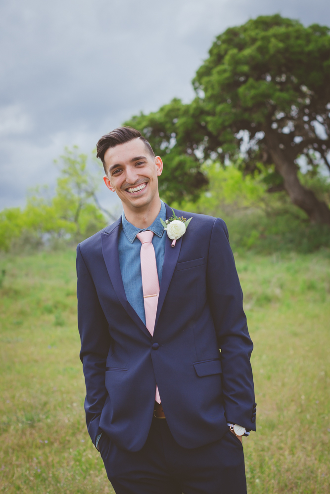 groom with pink tie and blue suit