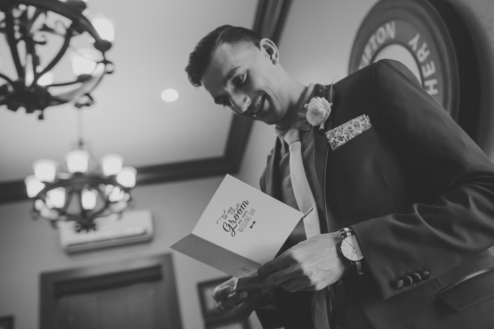 groom reading card from bride