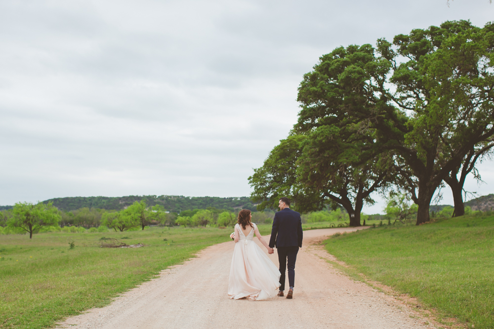 bride and groom walking down the road
