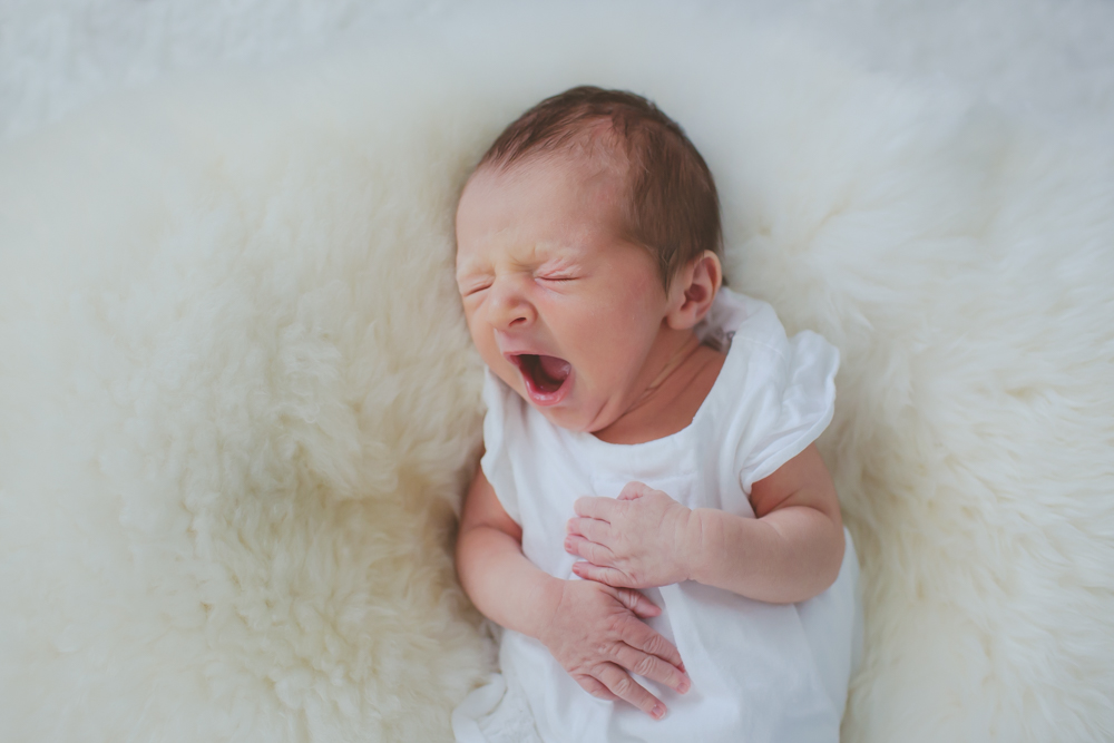 close up of newborn yawning