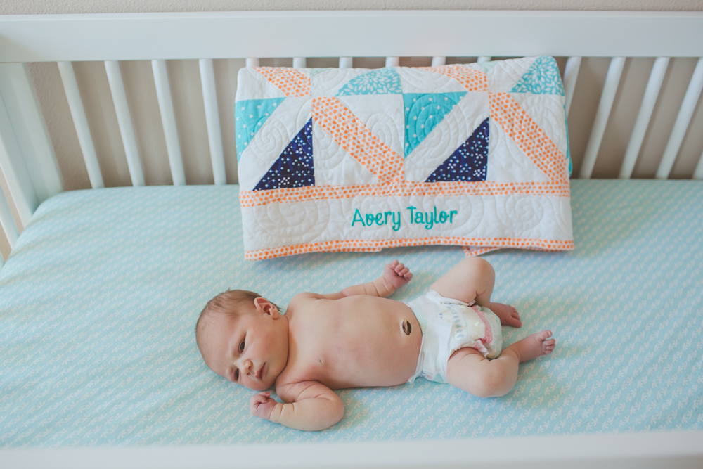 baby next to a quilt