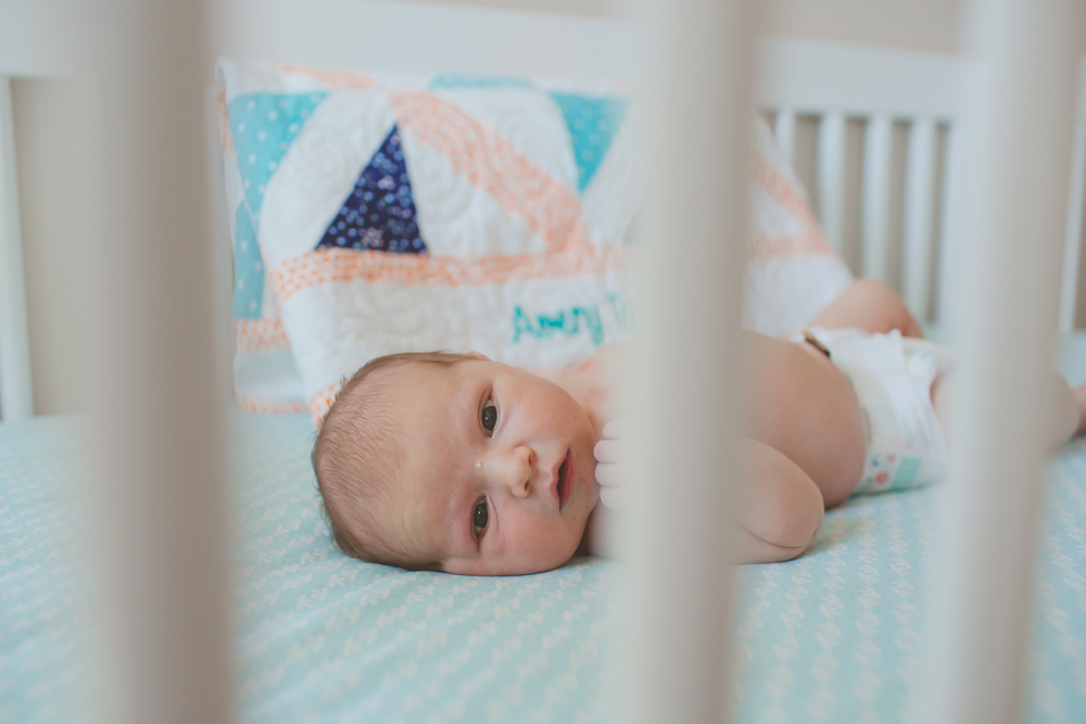 close up of baby through crib bars