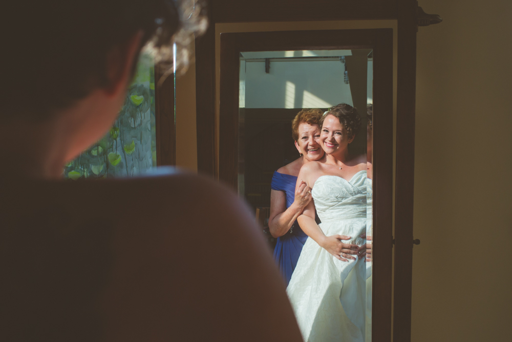 bride and mom's reflection in mirror