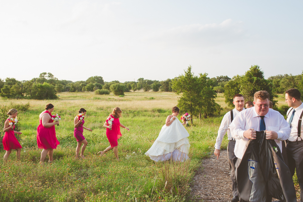 wedding party walking in a field