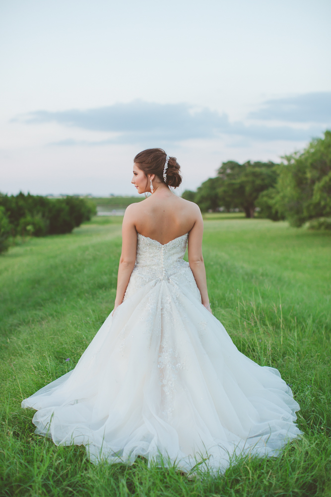 bride with dress bustled at sunset
