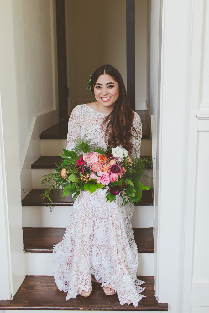 bride holding bouquet on stairs