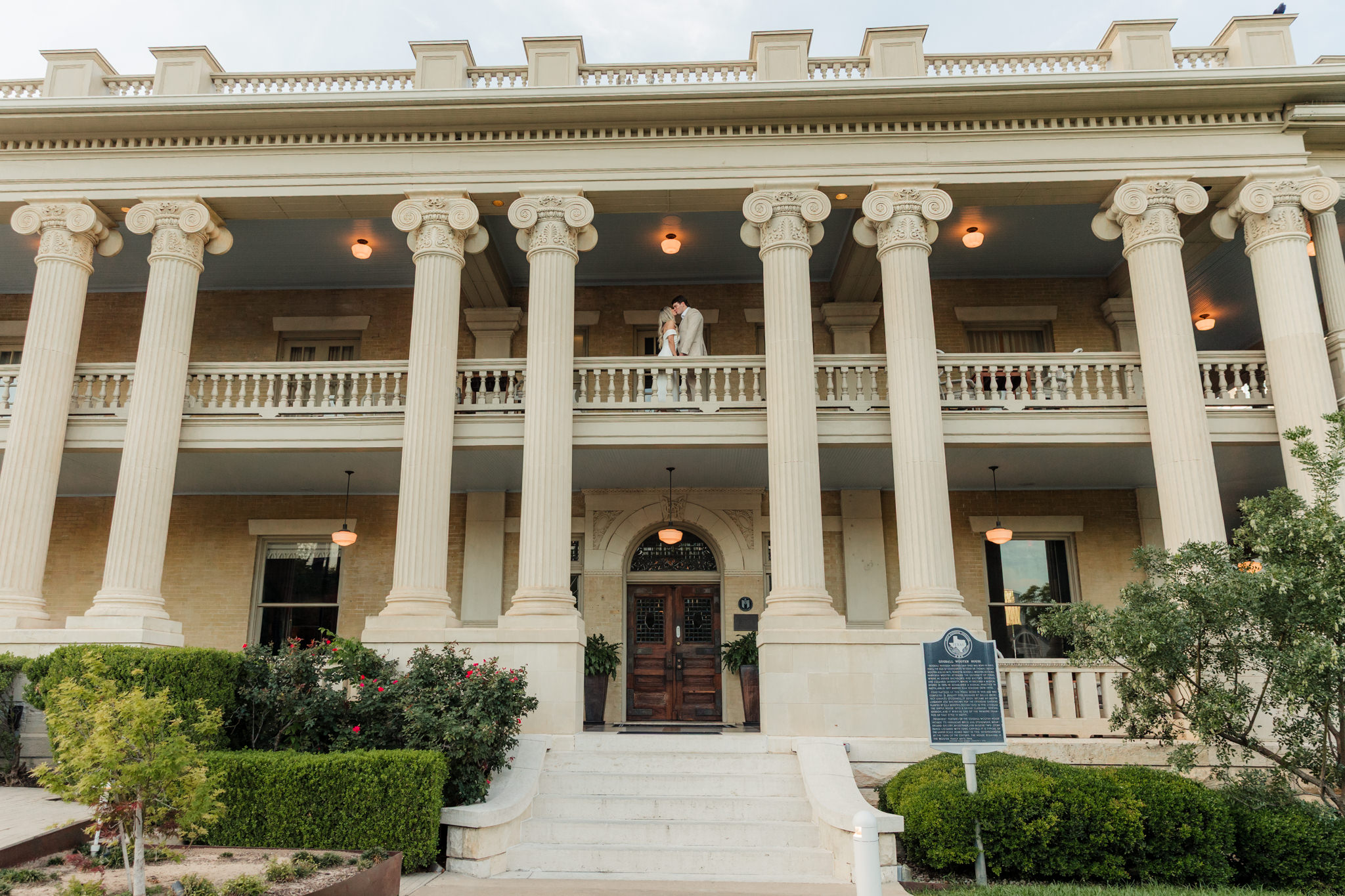 couple kissing on balcony at Hotel Ella