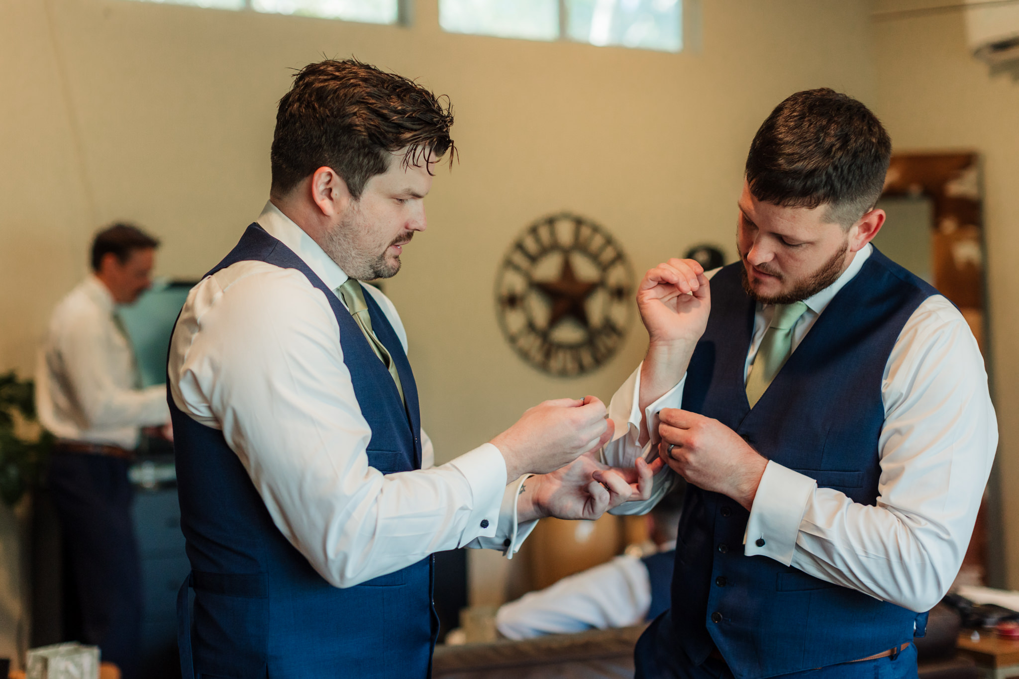 Hummingbird House groom getting ready with cuff links