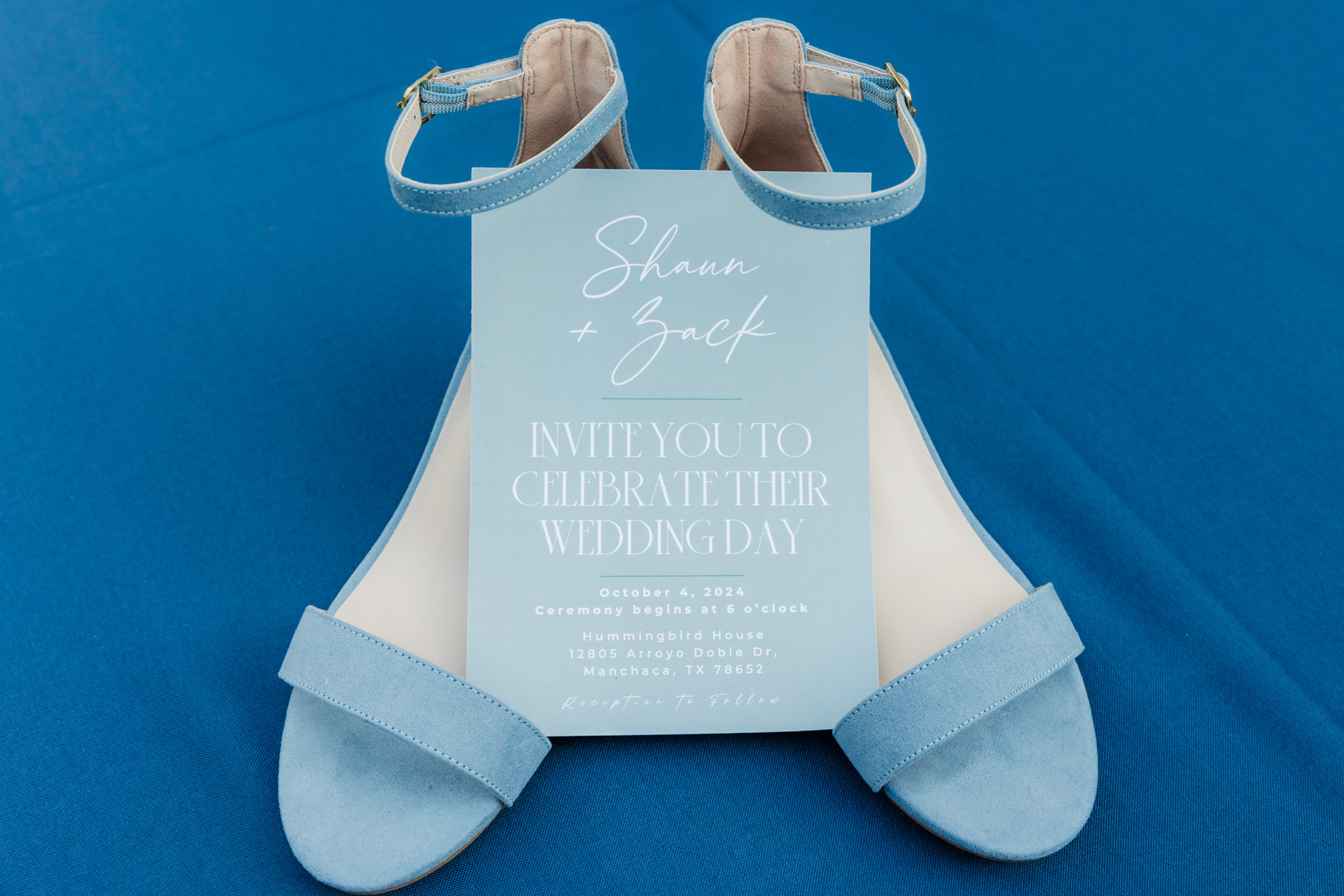 wedding invitation and bride's shoes