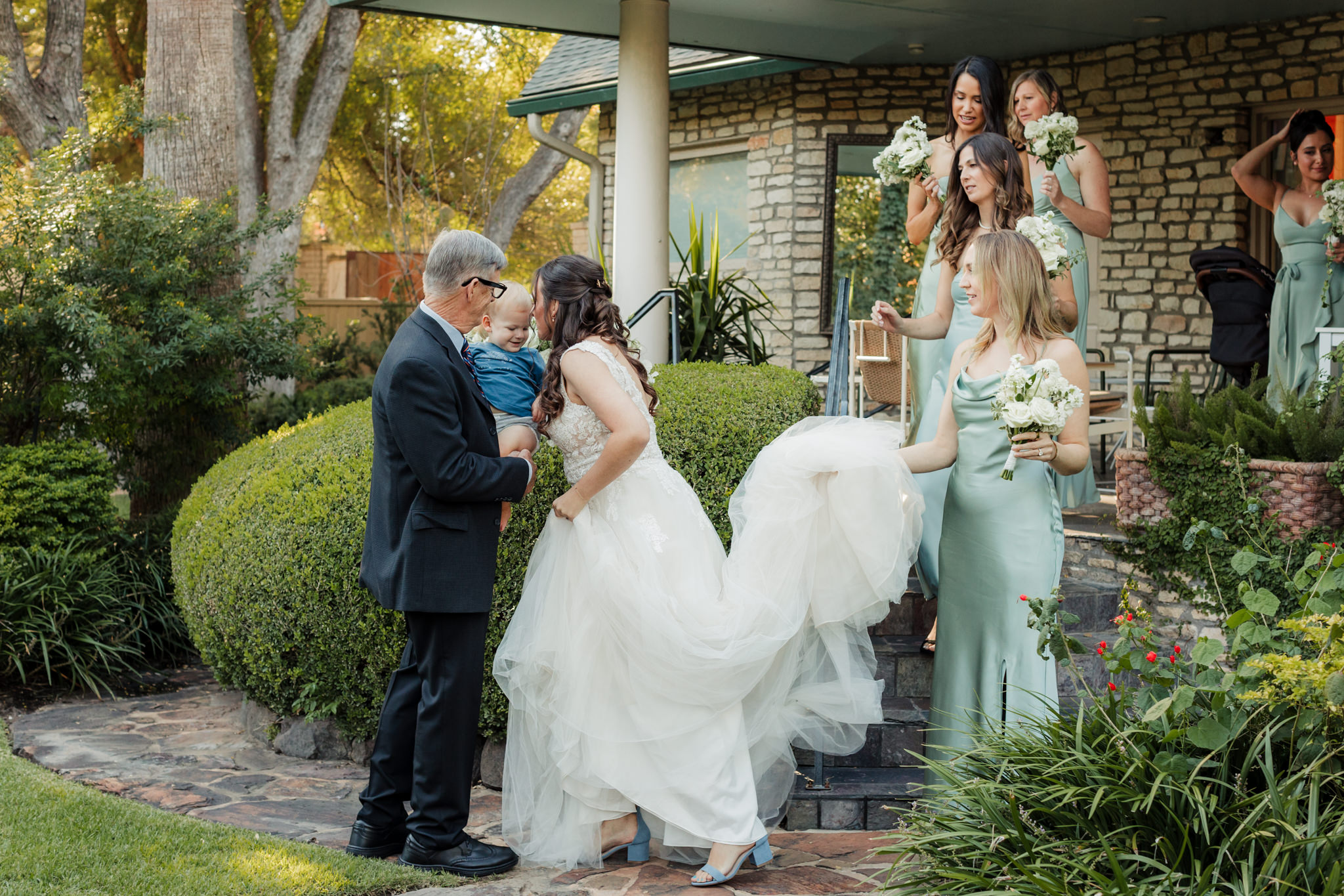 bride greeting her dad and son