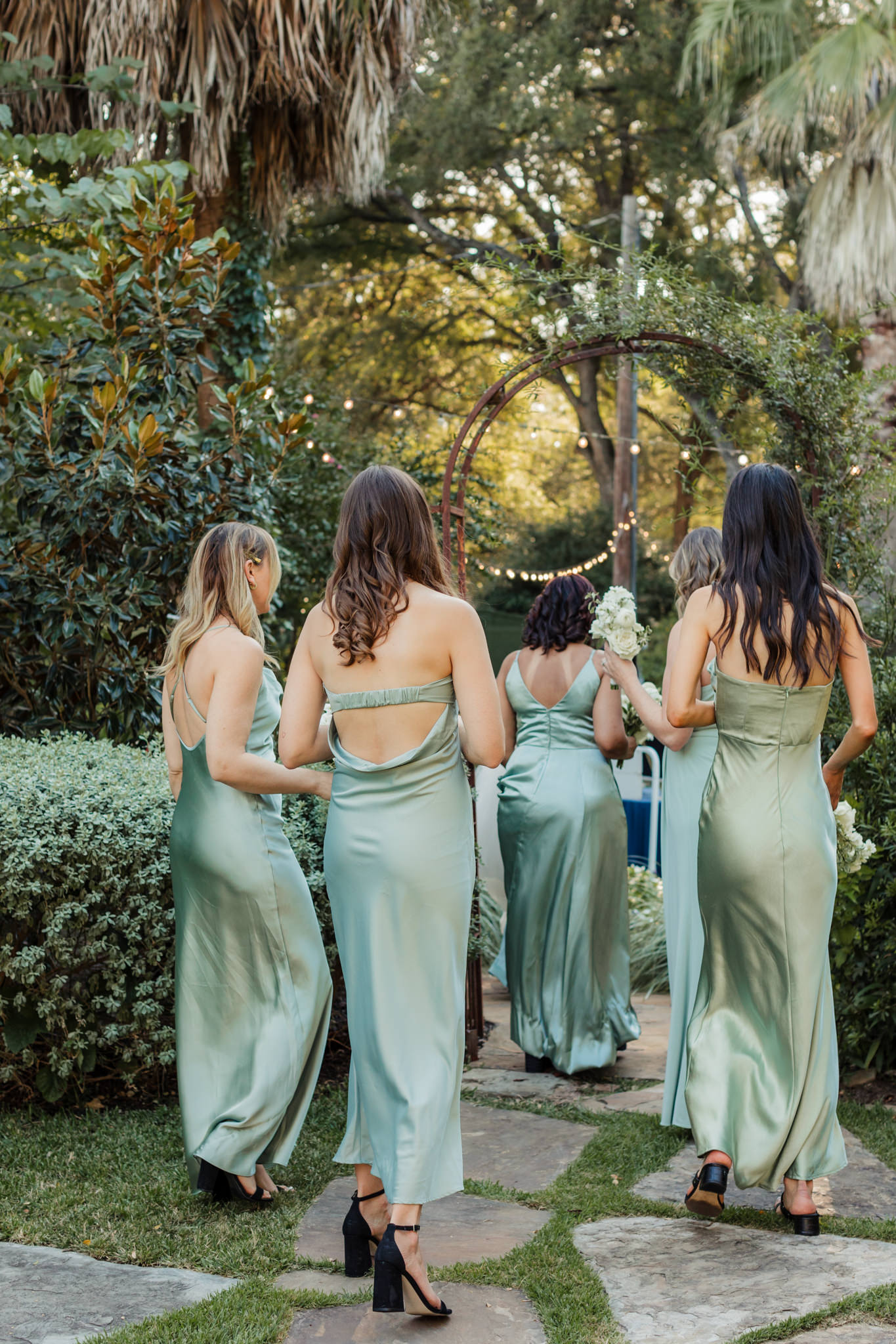 bridesmaids in green dresses walking away