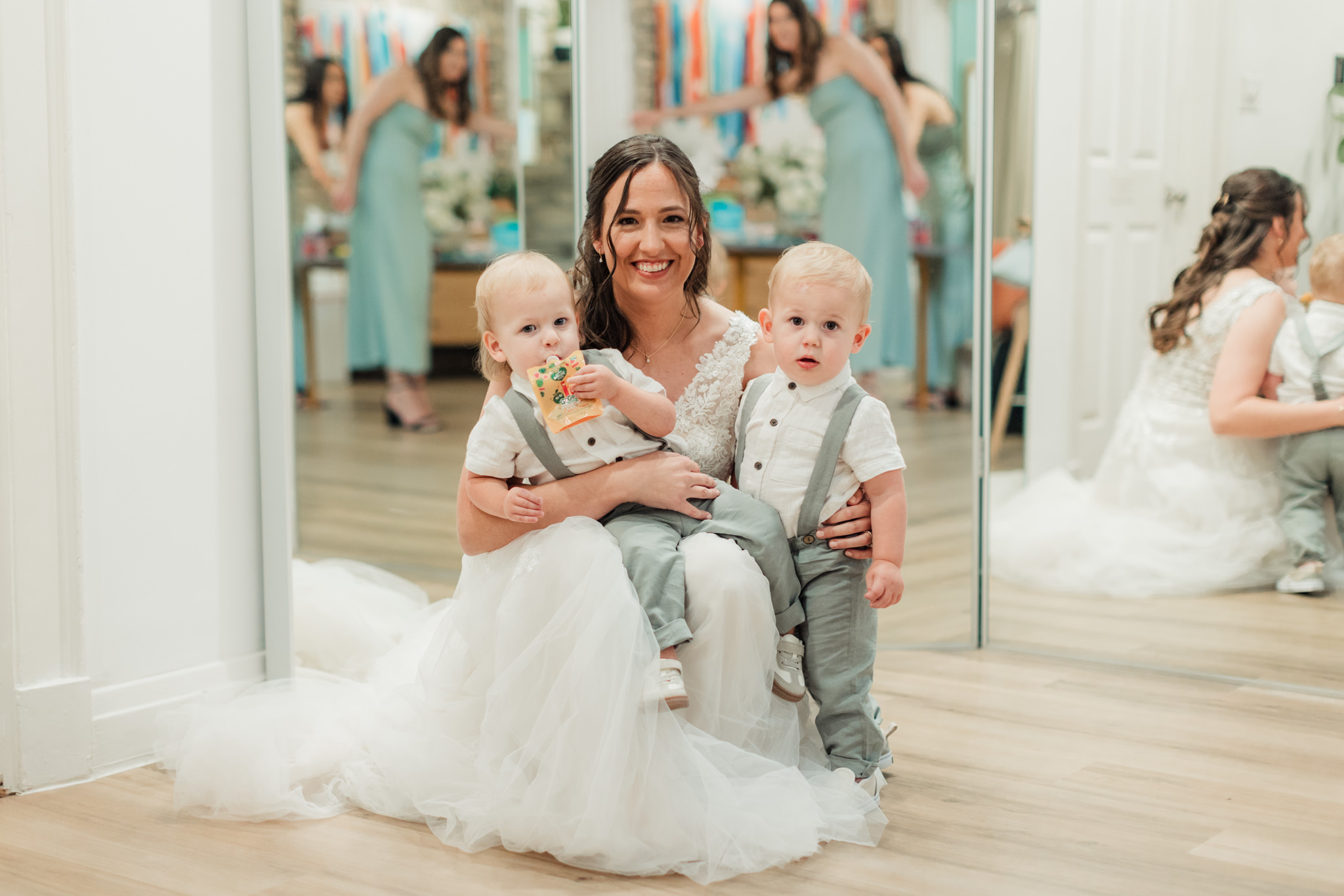 bride hugging her ring bearers