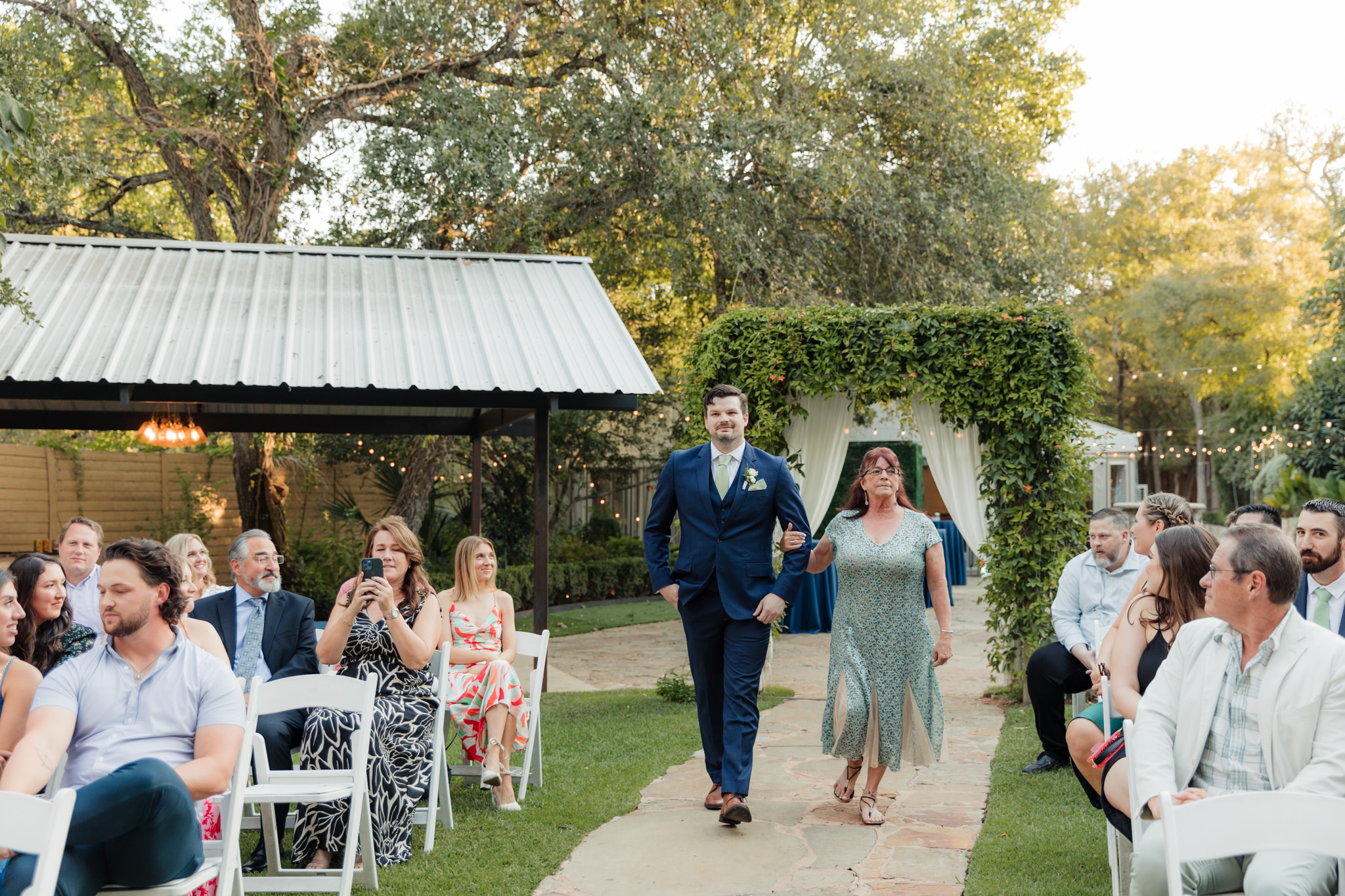 groom walking mom up the aisle