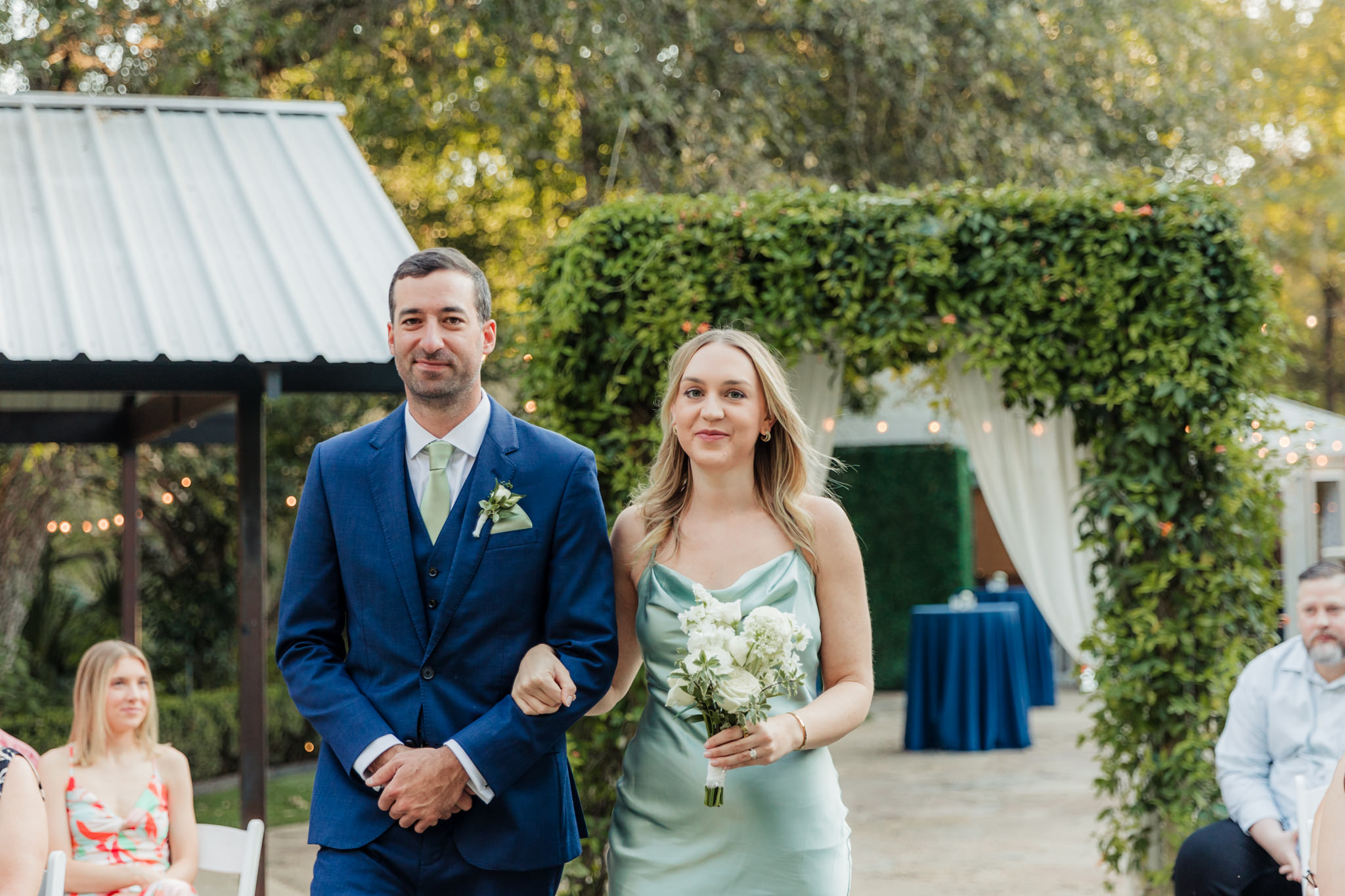 bridesmaid and groomsman walking up the aisle