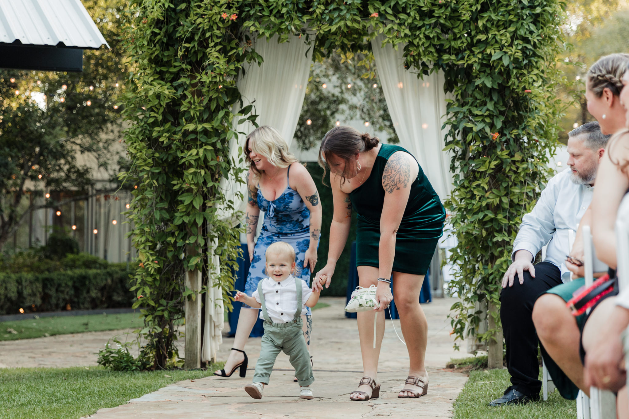 ring bearer walking up the aisle in overalls