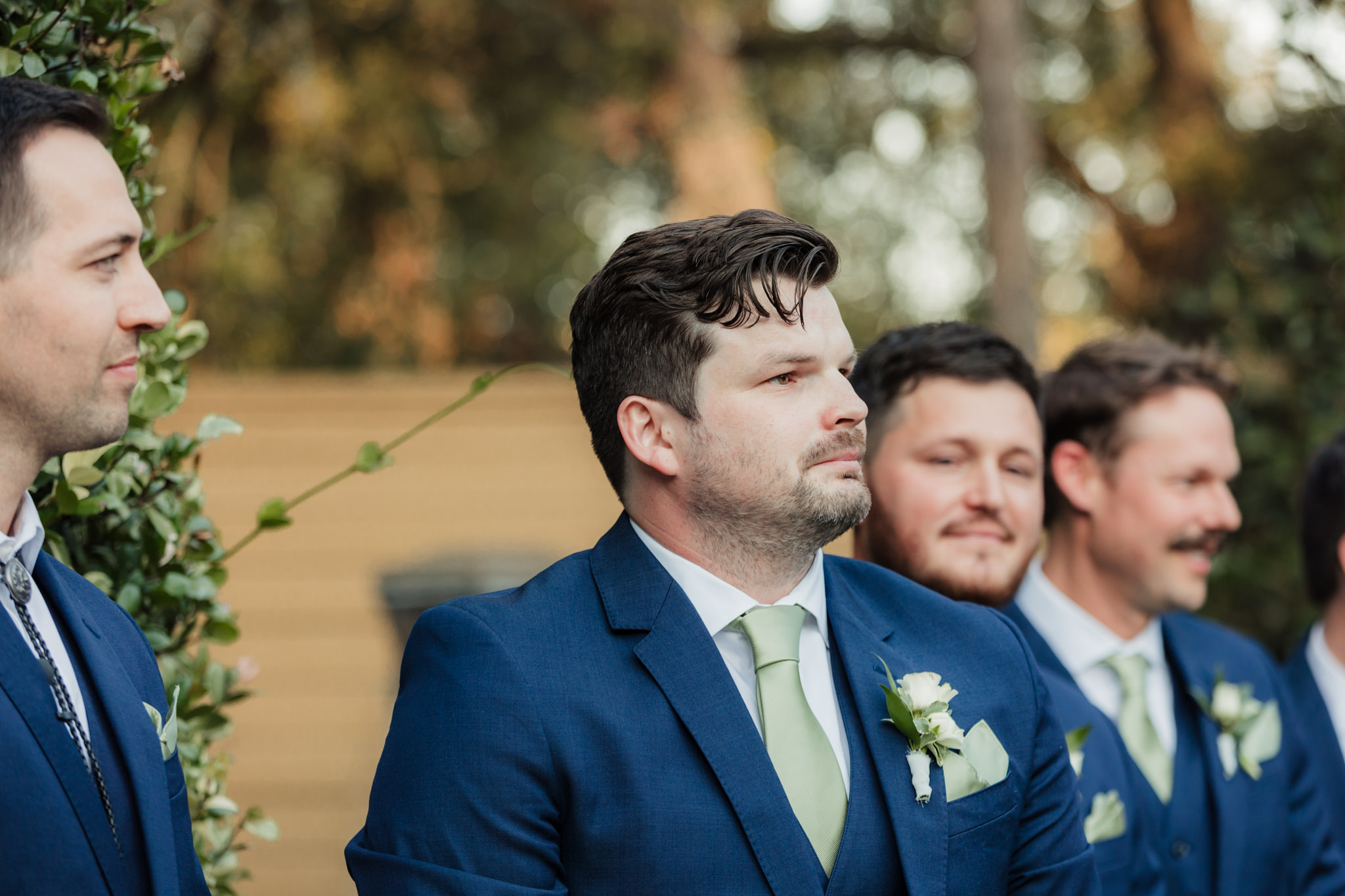 groom watching his bride walk down