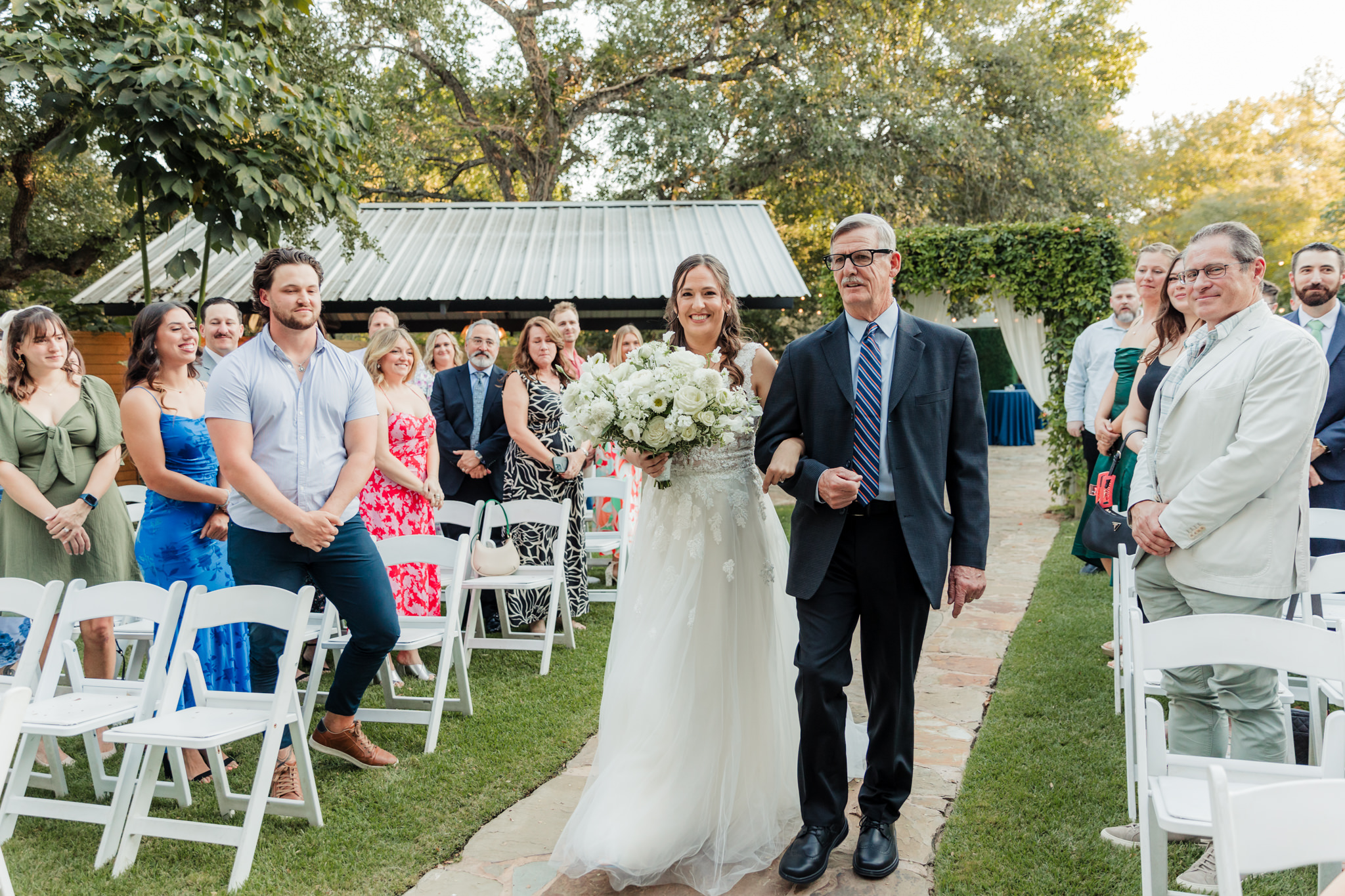 bride walking up the aisle with her dad