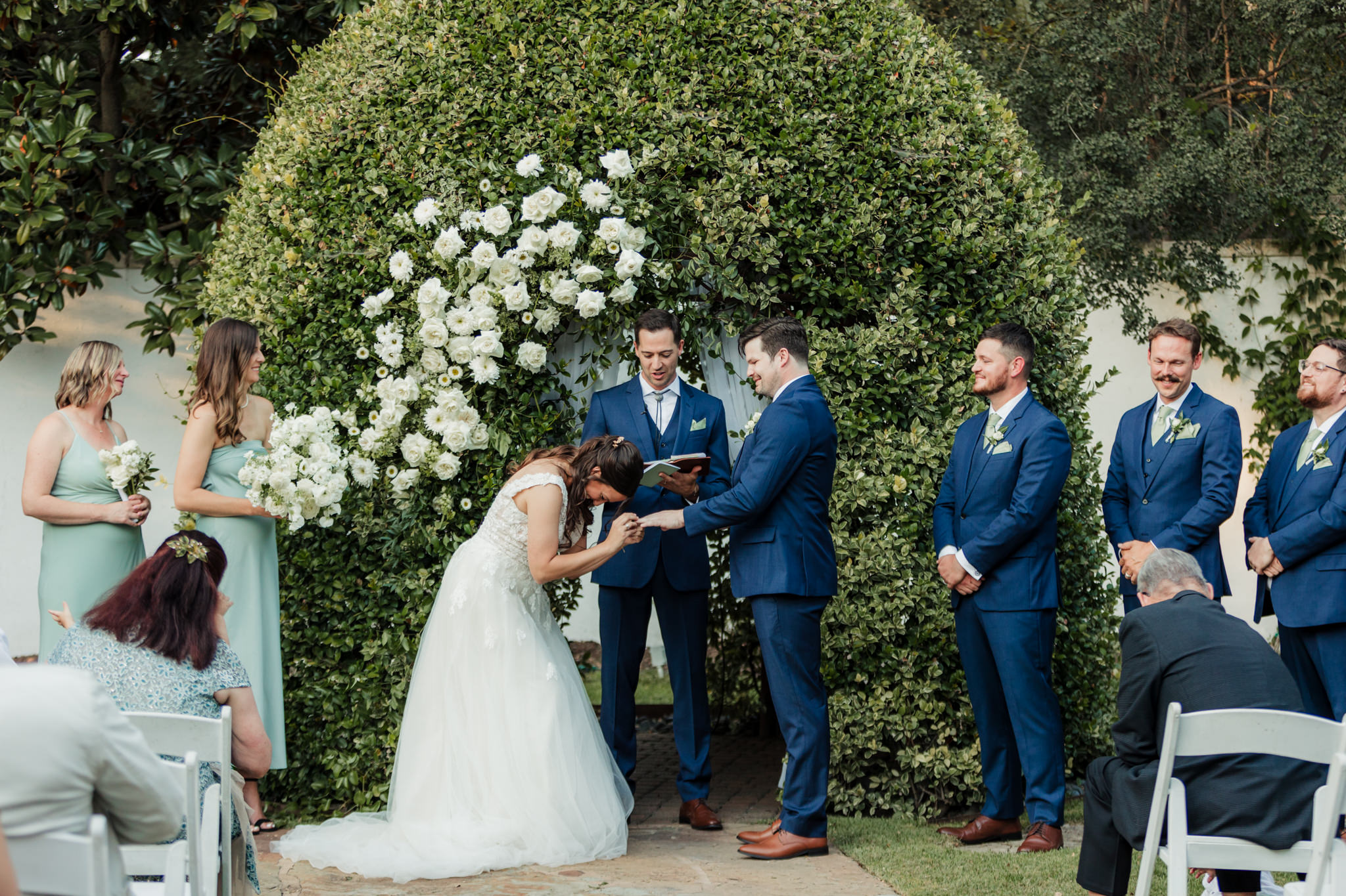 bride laughing and holding groom's hands