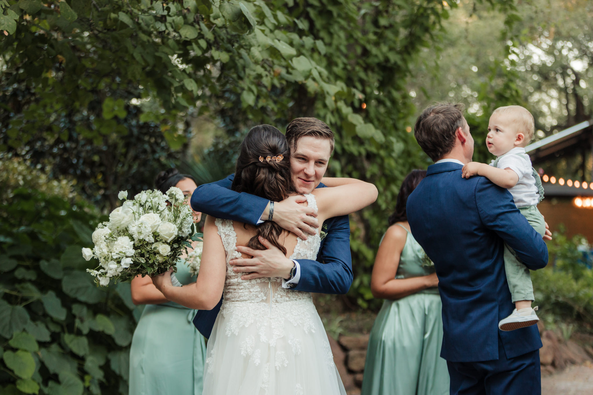 bride hugging groomsman