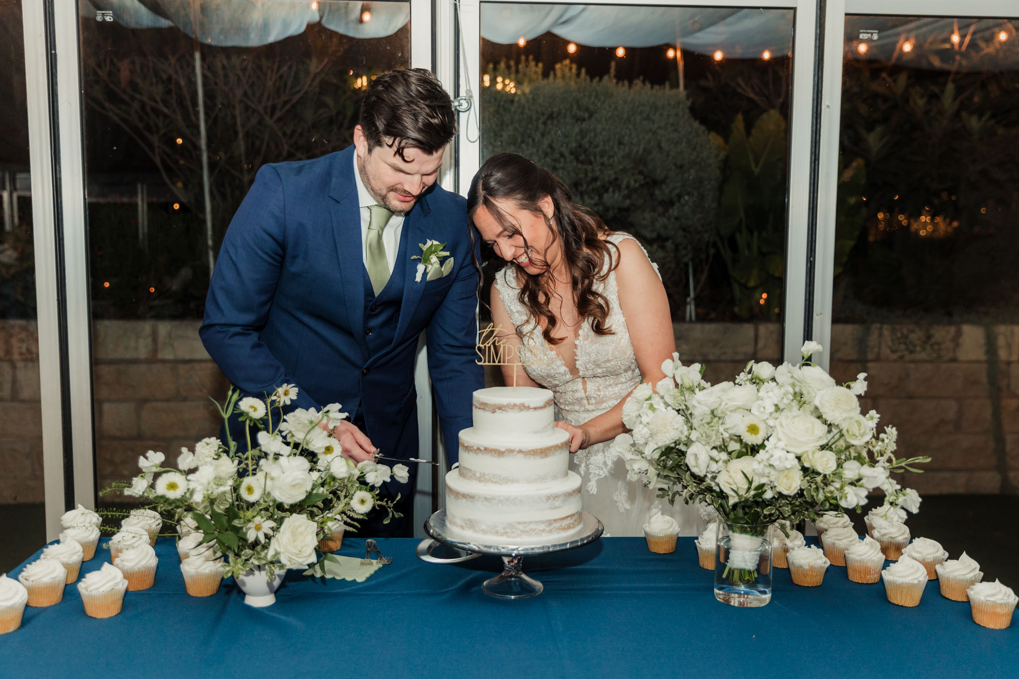 bride and groom cutting the cake