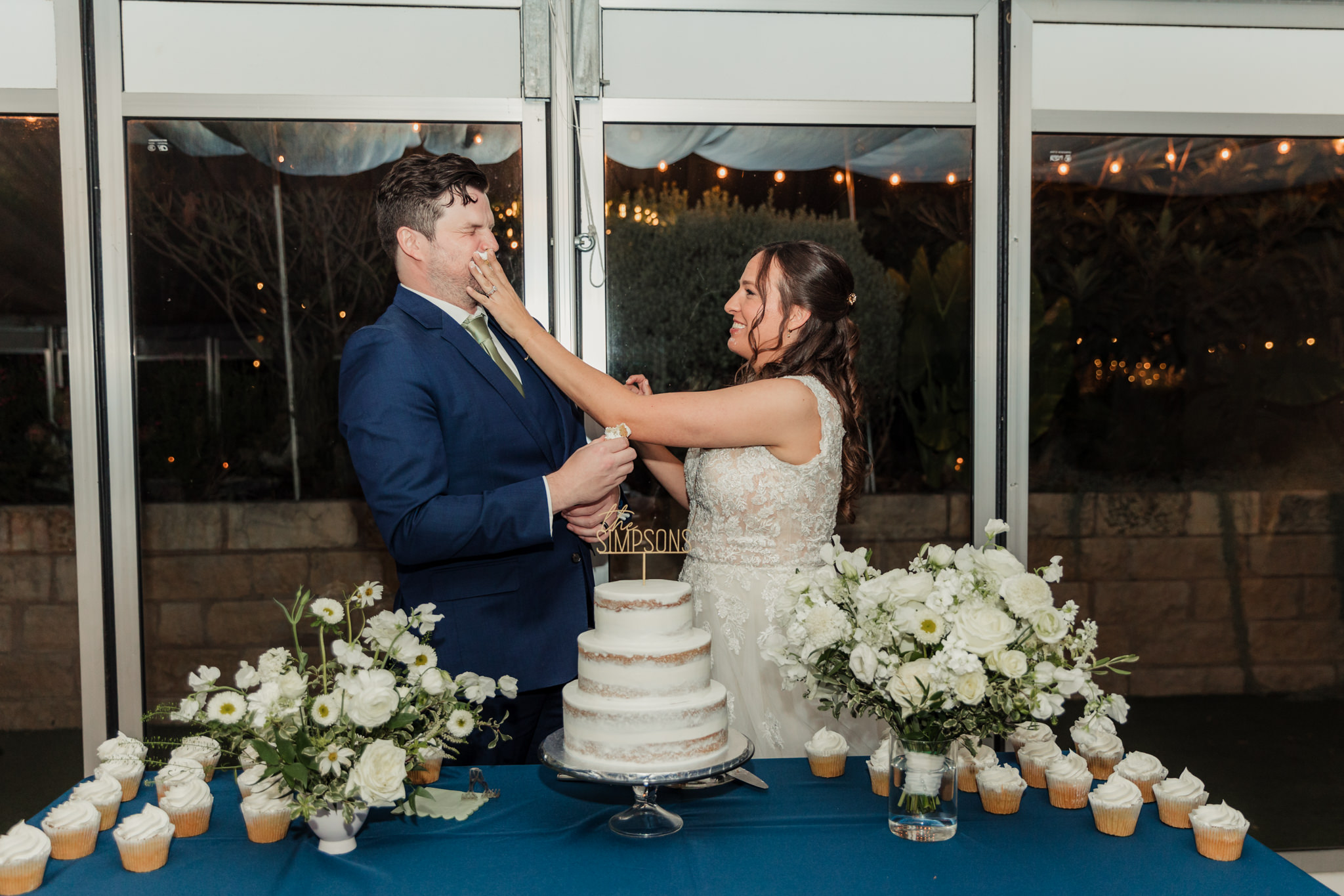 bride shoving cake in groom's face