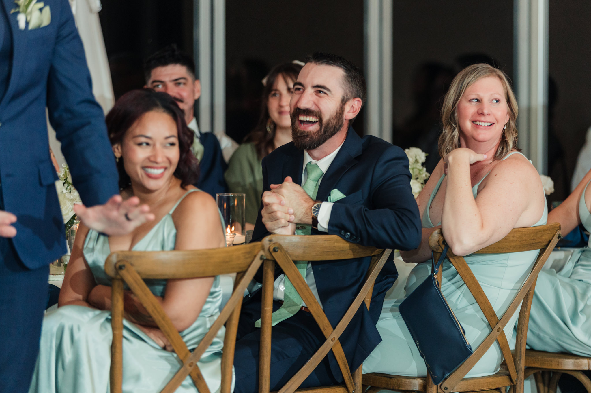 wedding party laughing during toasts