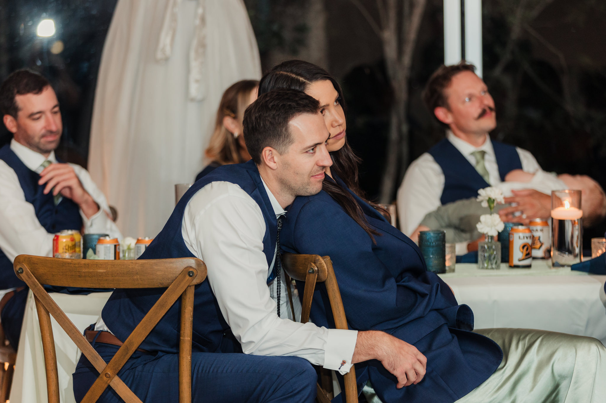 wedding party cuddling during toasts