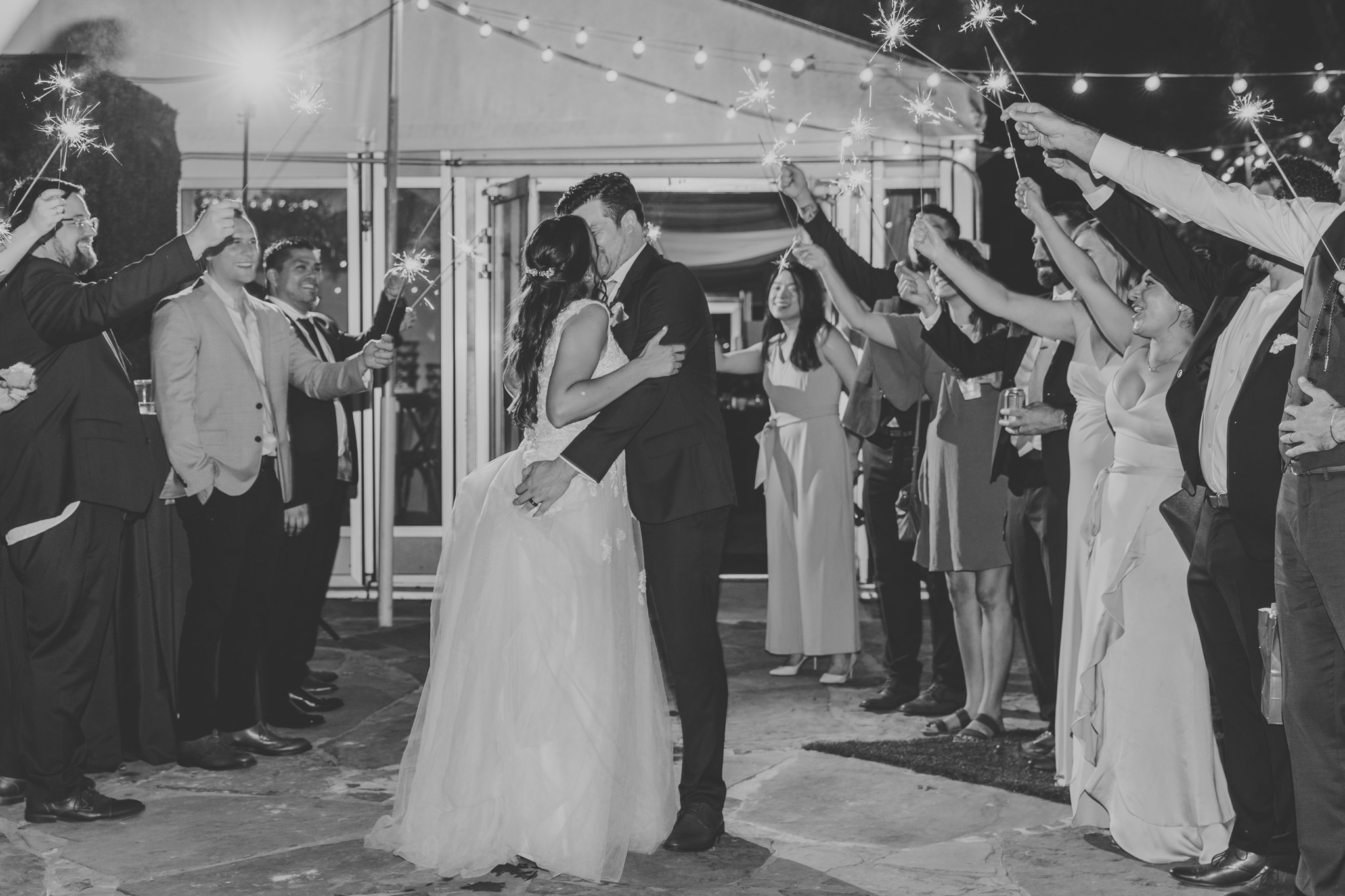 bride and groom sparkler exit kiss