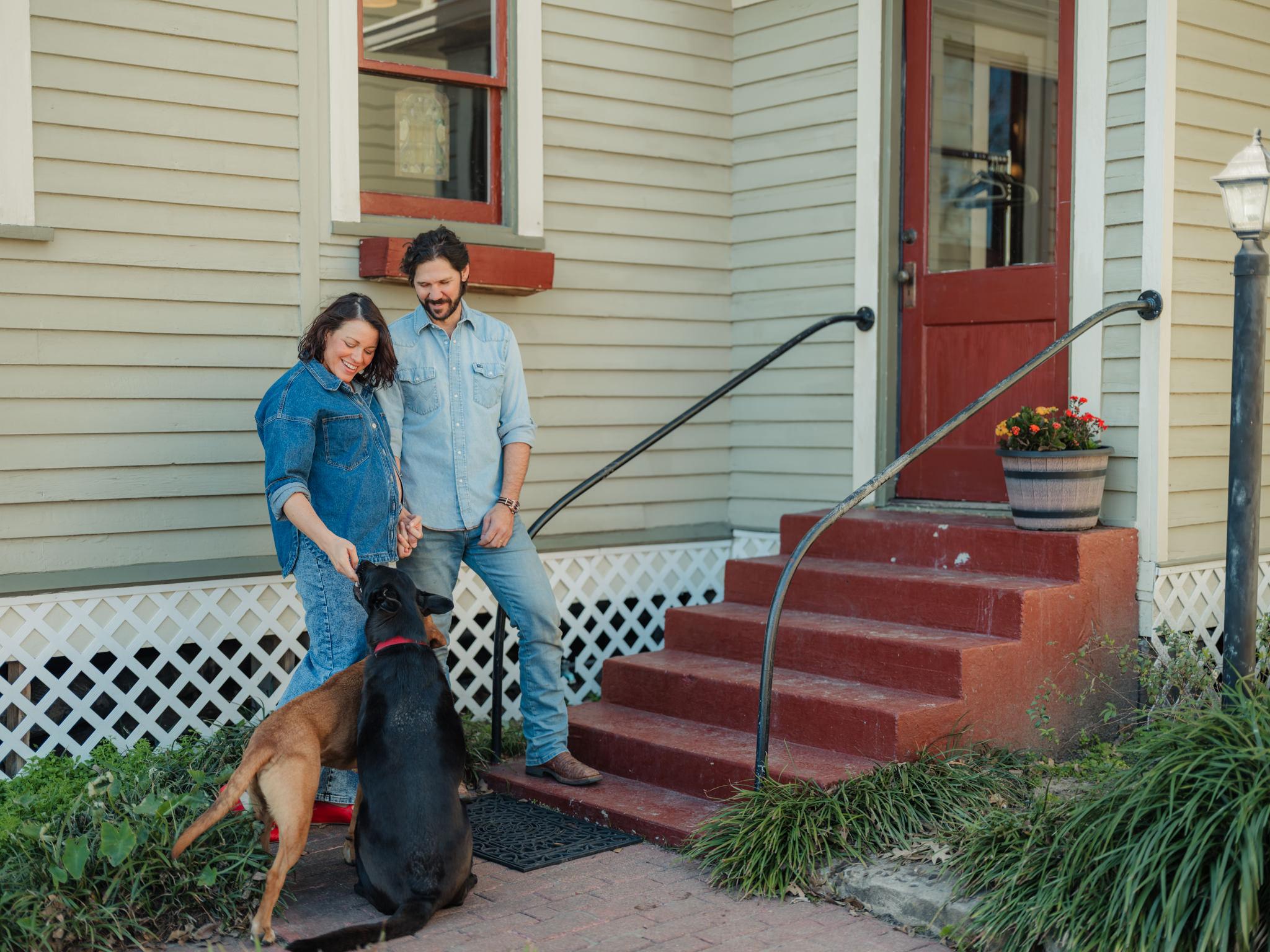Joy the Baker petting her dogs