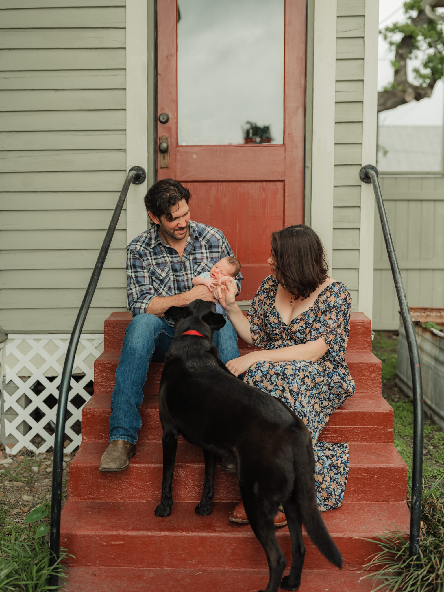 cuddling baby and dog on the porch steps