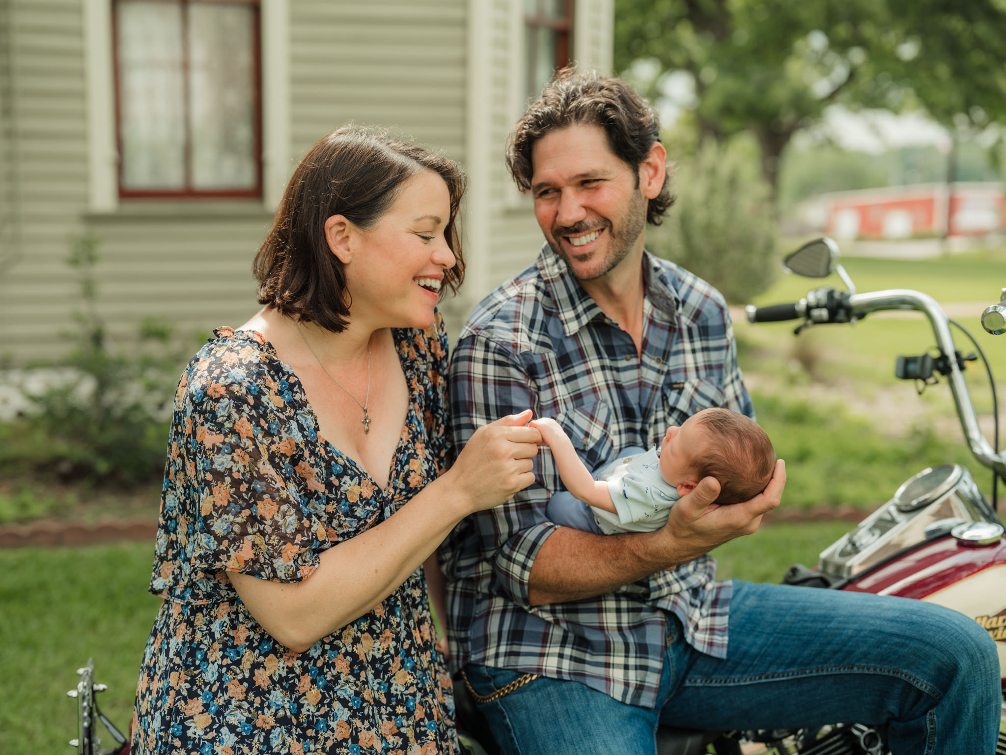 cuddling baby while sitting on a motorcycle