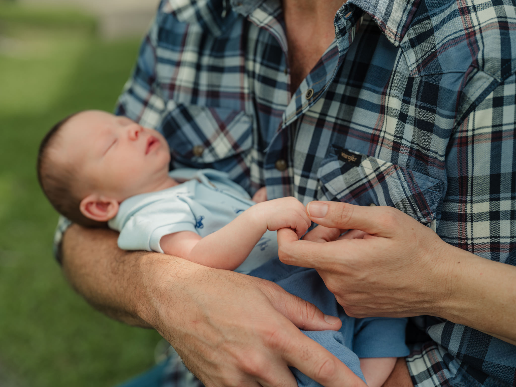 dad holding his newborn's hand